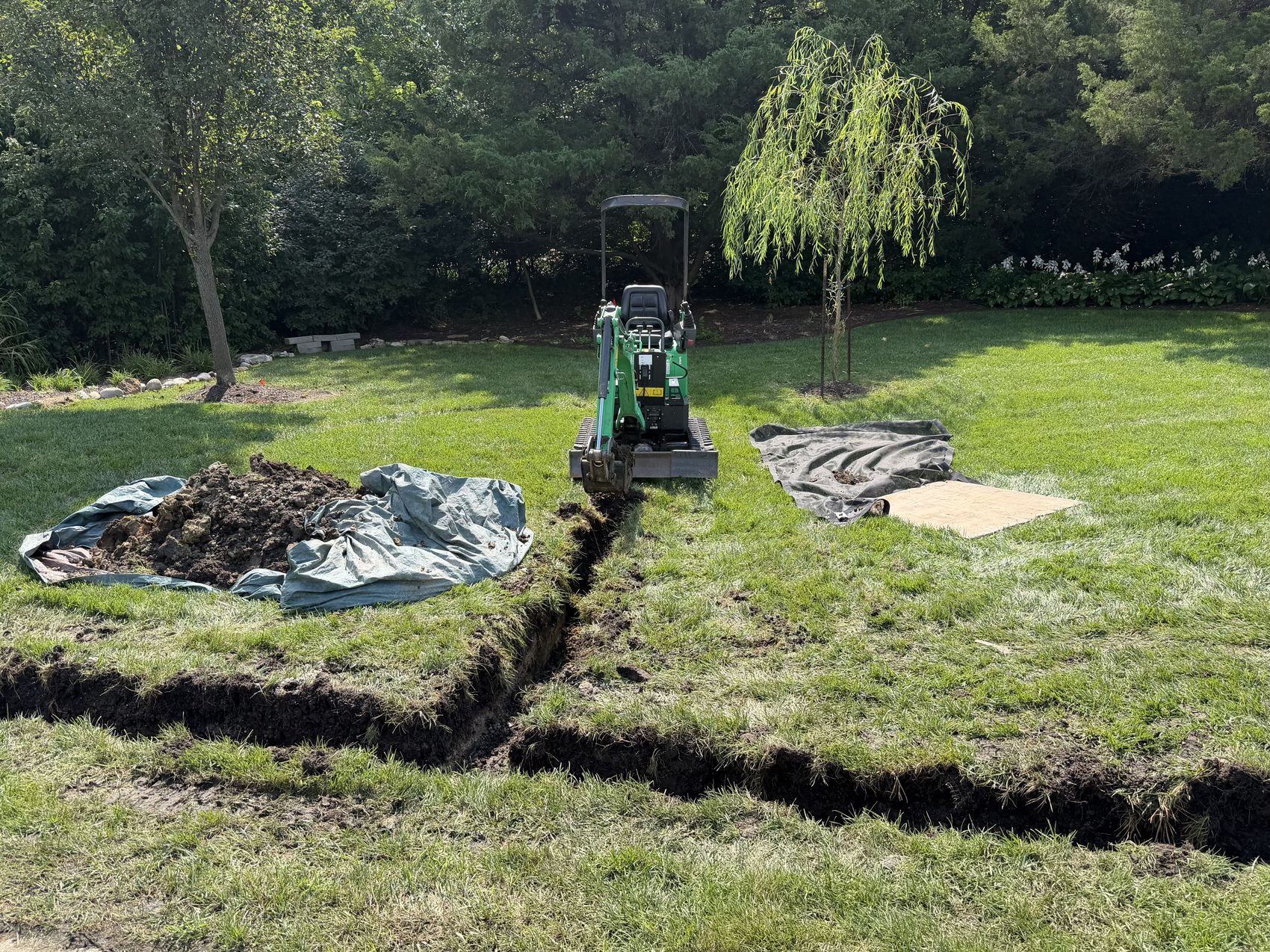 French drain trench across a large lawn