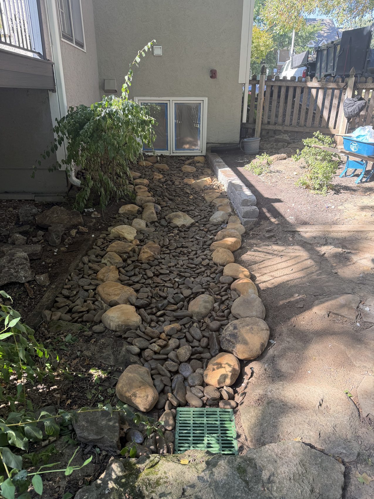 River-rock drainage channel installed along a home foundation in Kansas City